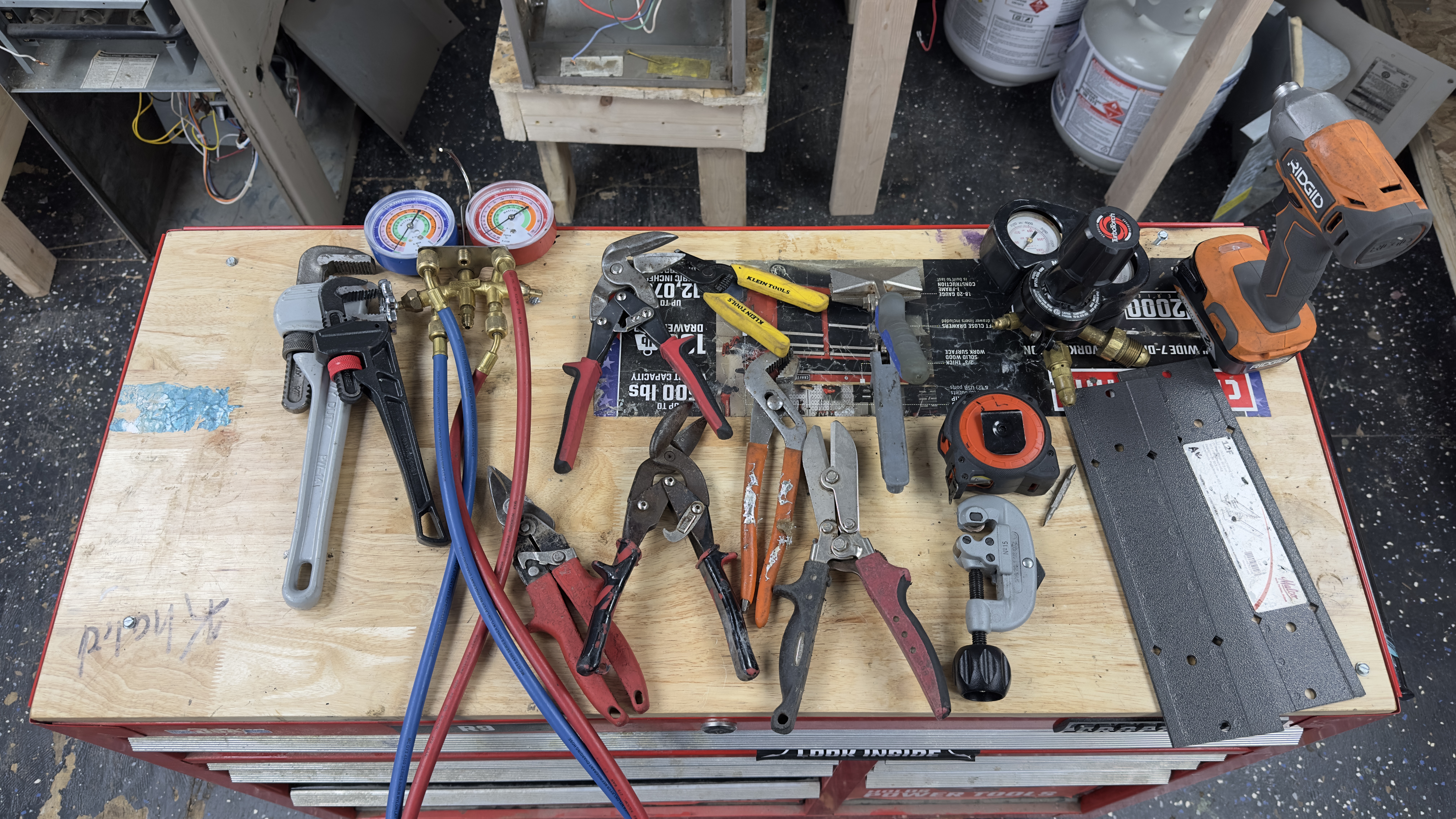 HVAC technician hand tools laid out on a workbench
